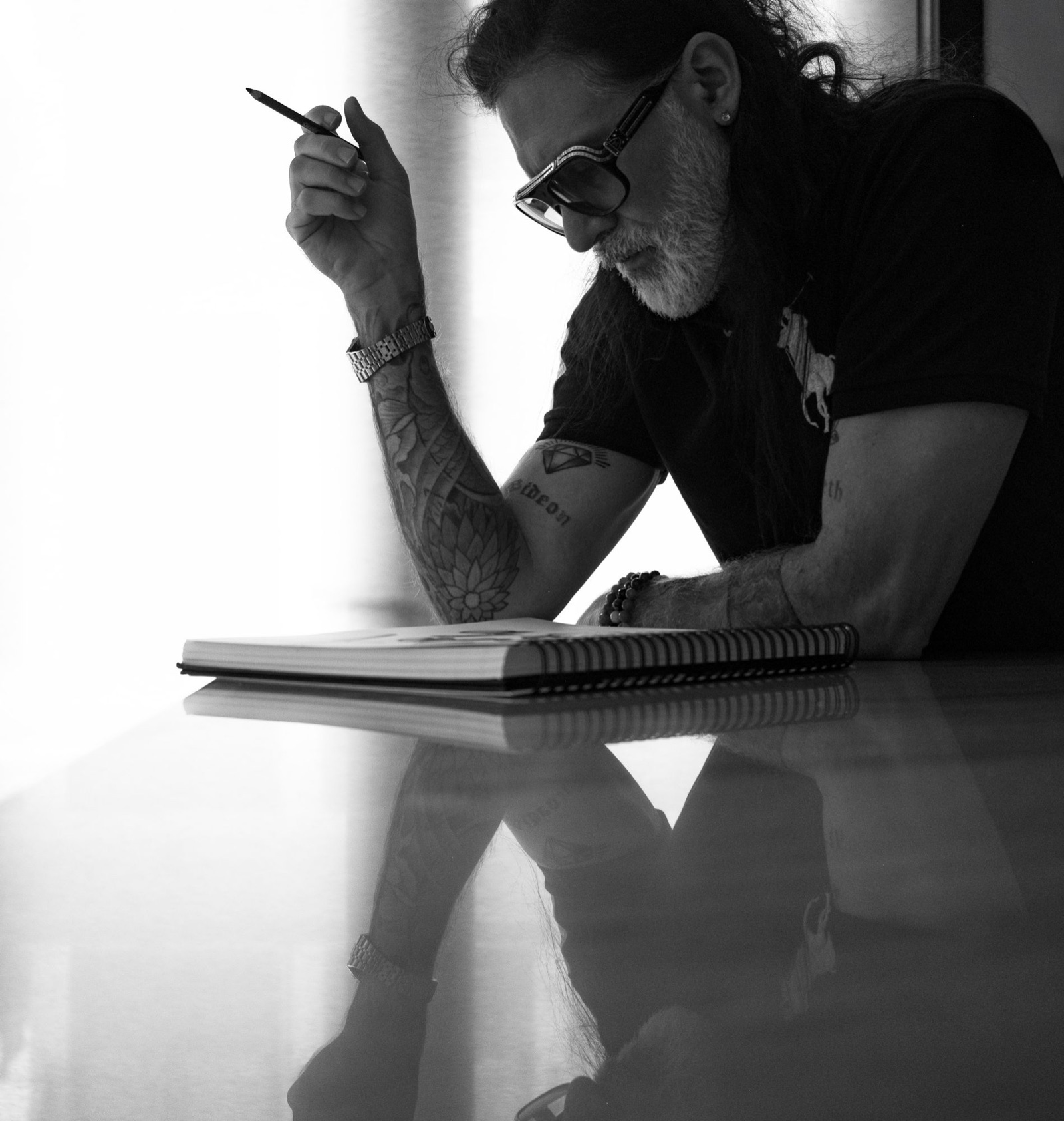 Gabriel Dean Roberts sketching at a table in a private residence