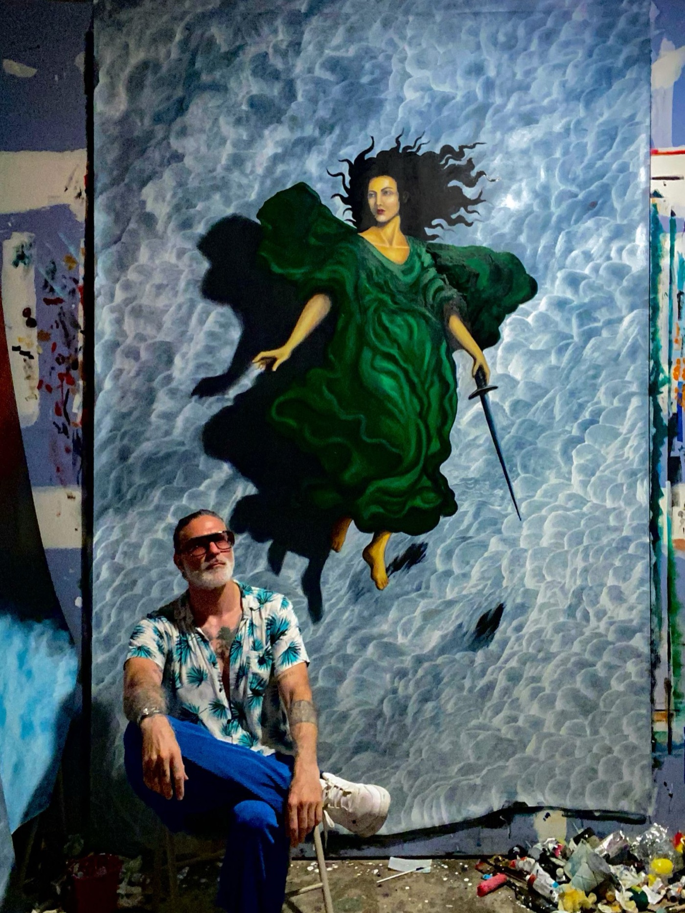 Gabriel Dean Roberts in the studio beside a large figure painting in progress